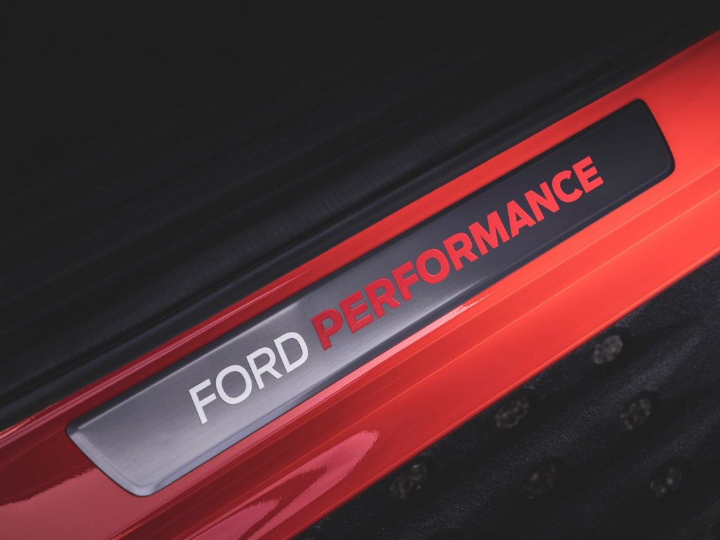 Ford Performance-Schriftzug an der Einstiegsleiste eines orangenen Ford Ranger Raptor 2022.