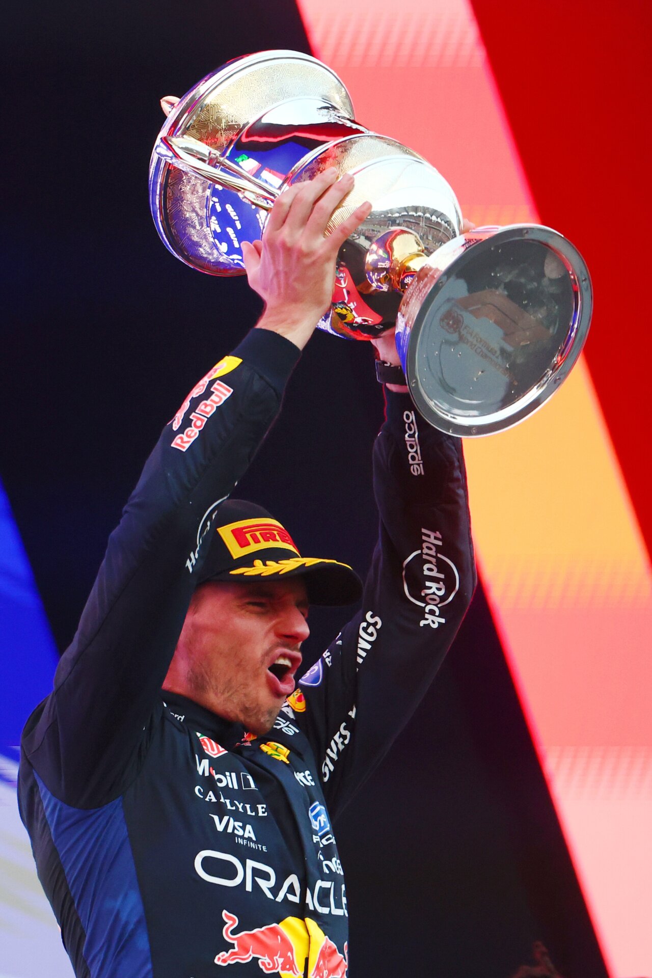 Max Verstappen hebt auf dem Podium in Sepang den Siegerpokal