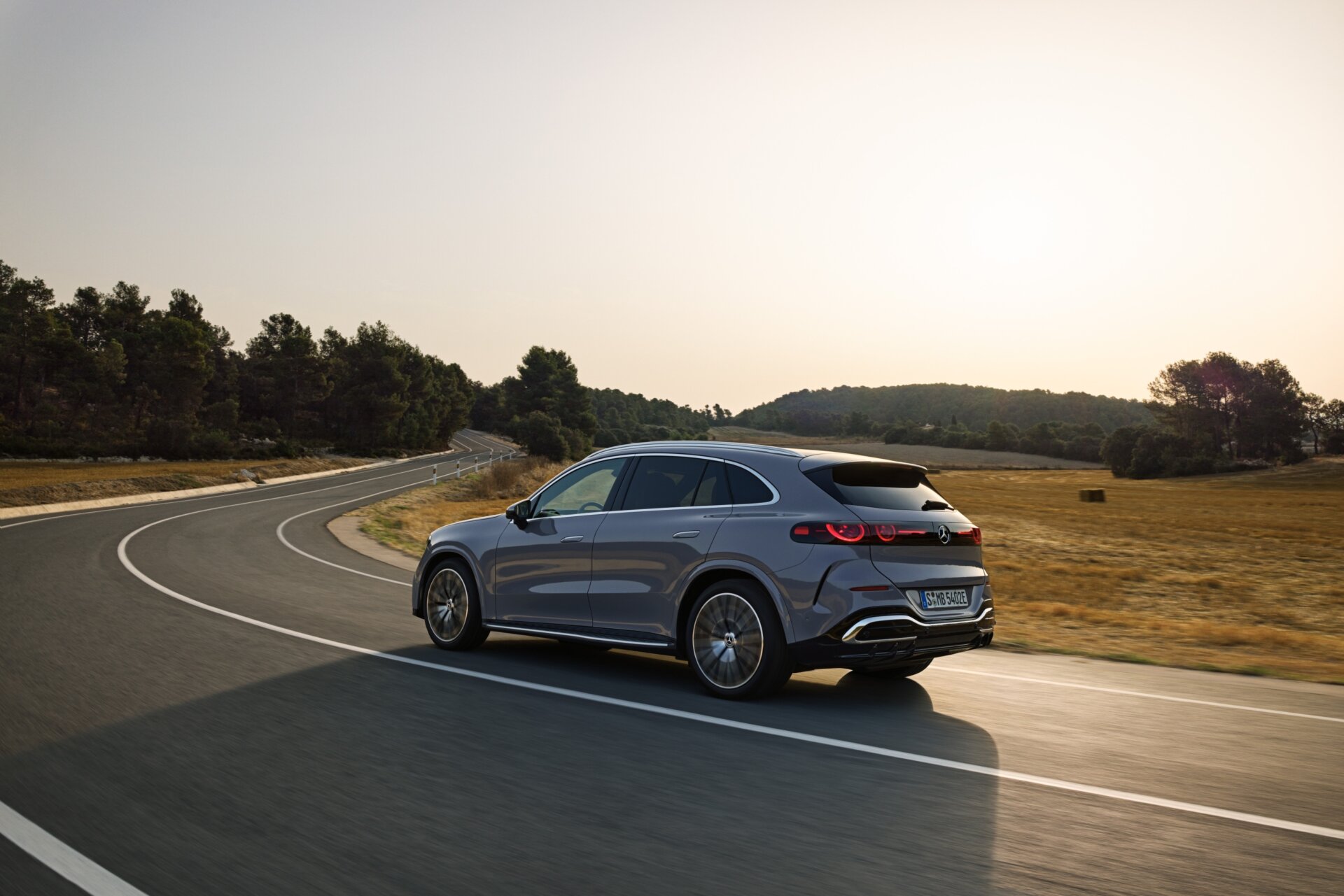 Mercedes GLC 400 4MATIC elektrisch in Fahrt auf einer Landstraße im Abendlicht
